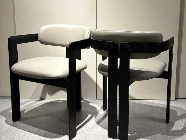 Modern dining chairs with upholstered seats, black wood frame, contemporary furniture design
